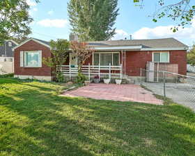 Rear view of property with a patio and brick siding