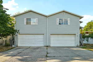 View of property exterior with driveway and a garage