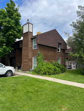 View of side of home with a chimney