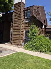 View of side of home with a yard