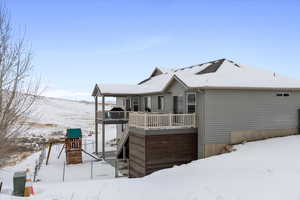 Snow covered house with a playground