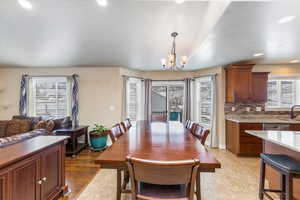 Dining area featuring recessed lighting, baseboards, and an inviting chandelier