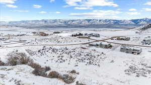 Snowy aerial view featuring a mountain view