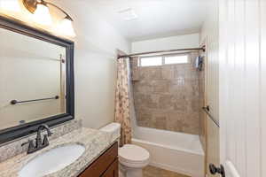 Full bathroom featuring toilet, vanity, and shower / bath combo