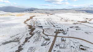 Snowy aerial view featuring a mountain view