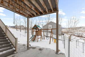 Exterior space featuring stairs, a playground, and fence