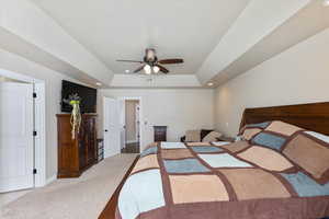 Bedroom with a raised ceiling, a ceiling fan, recessed lighting, carpet, and baseboards