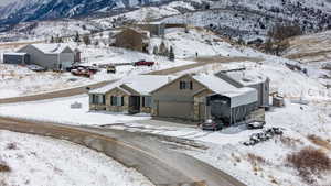Snowy aerial view featuring a mountain view