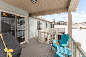 Snow covered deck with area for grilling