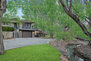 View of front of house with driveway, a front lawn, and a garage