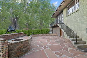 View of patio featuring stairway and an outdoor fire pit