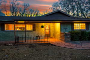 View of front of home with brick siding and a shingled roof