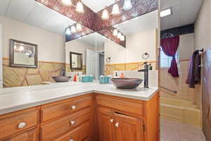 Full bathroom featuring vanity and tile patterned floors