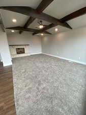 Unfurnished living room featuring baseboards, beam ceiling, recessed lighting, ceiling fan, and a fireplace
