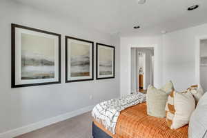 Bedroom featuring baseboards and carpet floors