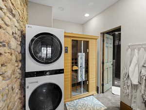 Laundry room with laundry area, recessed lighting, and stacked washer / drying machine