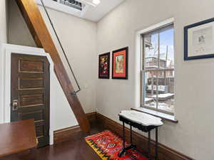 Stairs featuring baseboards and wood finished floors