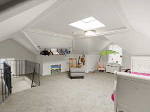 Loft bedroom featuring baseboards, lofted ceiling, and carpet floors