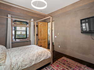 Main bedroom featuring wood finished floors and baseboards