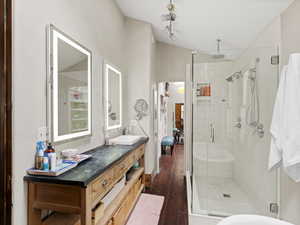 Bathroom with a stall shower, vanity, and hardwood / wood-style flooring