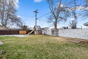 View of yard featuring an outbuilding, a fenced backyard, and a storage shed