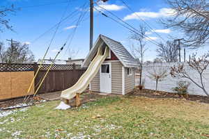 View of shed featuring a fenced backyard