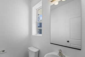 Half bathroom with a sink and toilet