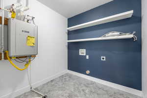 Utility room featuring tankless water heater