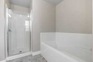 Master Bathroom Full bathroom featuring a bath, a stall shower, and a textured ceiling