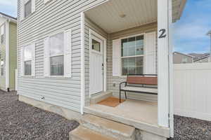 View of exterior entry featuring fence