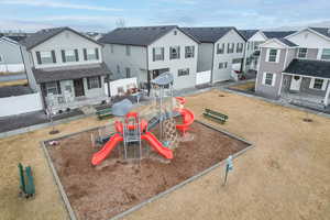 View of playground with fence and a residential view