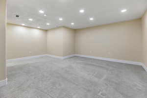 Unfurnished room featuring baseboards, recessed lighting, visible vents, and light carpet