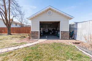 Detached garage featuring fence