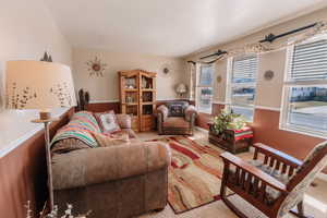 Living area featuring baseboards and carpet floors