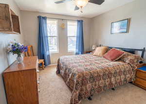 Bedroom with light colored carpet and ceiling fan