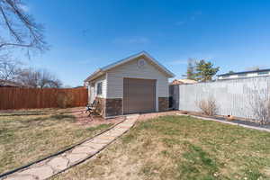 Detached garage featuring fence