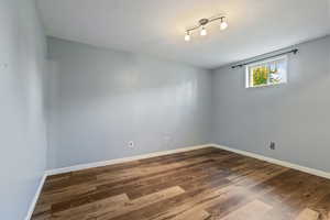 Empty room featuring baseboards and wood finished floors