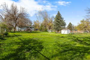 View of yard with a shed and an outbuilding