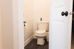 Bathroom featuring tile patterned flooring, toilet, and baseboards