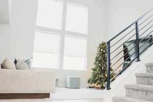 Stairs featuring a towering ceiling