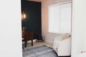 Sitting room featuring baseboards and wood finished floors