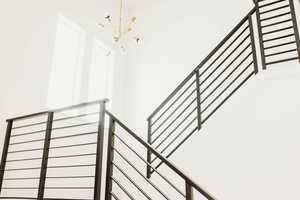 Stairway featuring a notable chandelier