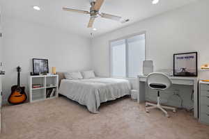 Carpeted bedroom with recessed lighting, visible vents, and ceiling fan