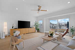 Living room with light wood finished floors, recessed lighting, and ceiling fan
