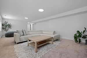 Carpeted living room featuring recessed lighting, visible vents, and baseboards