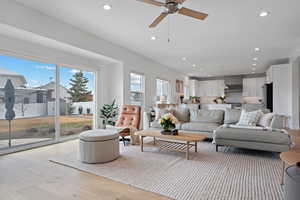 Living area with recessed lighting, light wood-style flooring, and ceiling fan