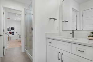Full bath featuring vanity, a shower stall, recessed lighting, and tile patterned floors