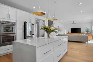Kitchen featuring recessed lighting, appliances with stainless steel finishes, ceiling fan, and light wood finished floors
