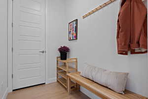 Mudroom with baseboards and light wood finished floors