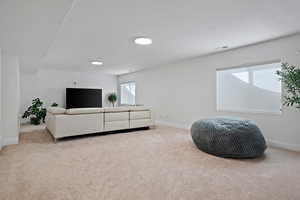 Living room featuring visible vents, baseboards, and carpet flooring